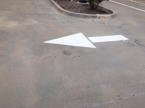 White Directional Arrow Painted In Parking Lot Beaumont, TX